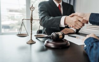 Lawyer shaking hands with a client over a desk